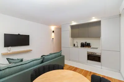 a living room with a couch and a tv at GuestReady - Dream Vitoria Apartment in Porto