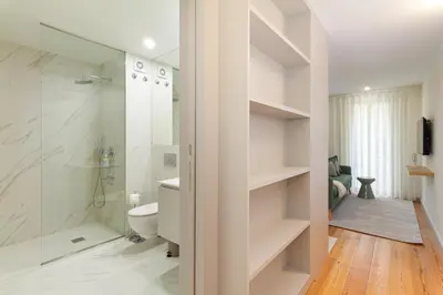 a bathroom with a toilet and a walk in shower at GuestReady - Dream Vitoria Apartment in Porto