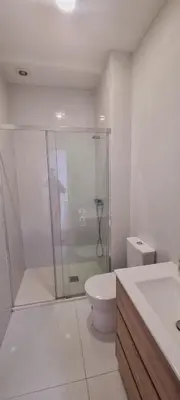 a bathroom with a shower and a toilet and a sink at Owls Hostel Ribeiro in Porto