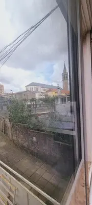 a view of a city from a window at Owls Hostel Ribeiro in Porto
