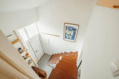 a white room with stairs and a picture on the wall at Modern Studio by Hosty in Porto