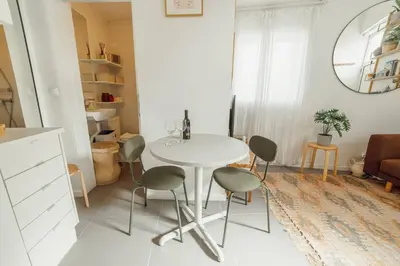 a white dining room with a table and chairs at Modern Studio by Hosty in Porto