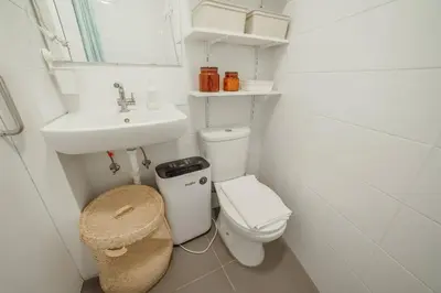 a small white bathroom with a toilet and a sink at Modern Studio by Hosty in Porto