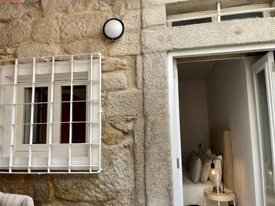 a stone wall with a window in a room at Douro River Charming Flats in Porto
