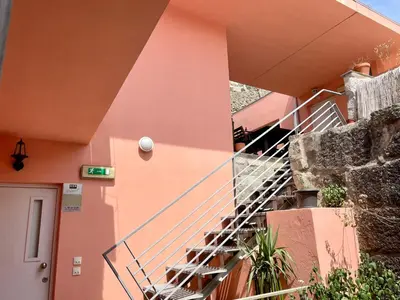 a staircase in the side of a pink building at Douro River Charming Flats in Porto