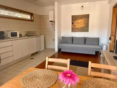 a kitchen and living room with a couch and a table at Douro River Charming Flats in Porto