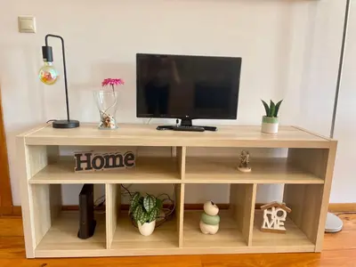 a wooden tv stand with a television on top at Douro River Charming Flats in Porto