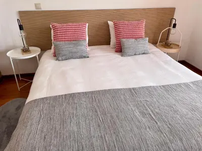 a large bed with two pillows on top of it at Douro River Charming Flats in Porto