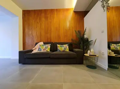 a living room with a brown couch with two pillows at INSOLI I Porto by Apartments2Stay in Porto