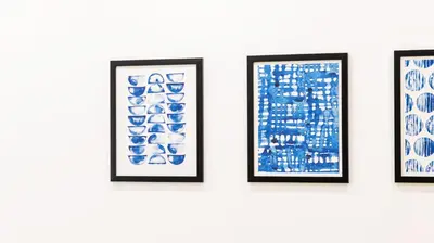 a group of framed paintings on a wall at Porto River Flat w/ Patio by LovelyStay in Porto