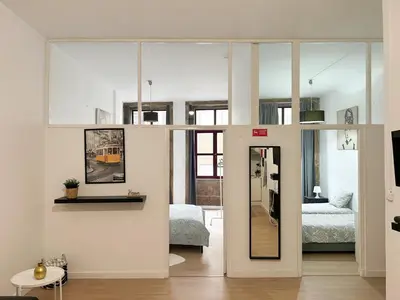 a living room with a room with a bed and a mirror at Oporto Central Flat - Downtown in Porto