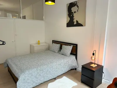 a small bedroom with a bed and a mirror at Oporto Central Flat - Downtown in Porto