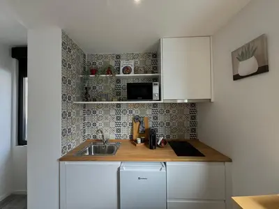 a small kitchen with a sink and a microwave at Casas da Corujeira 2 in Porto