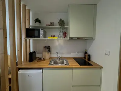 a kitchen with a sink and a microwave at Casas da Corujeira 2 in Porto