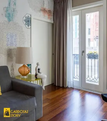 a living room with a chair and a table at Cardosas Story Apartments by Porto City Hosts in Porto