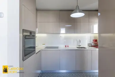 a white kitchen with white cabinets and a sink at Cardosas Story Apartments by Porto City Hosts in Porto
