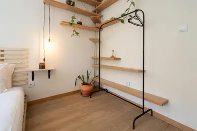 a living room with a black floor lamp and a couch at Jardim do Morro Apartment By Porto Stories in Vila Nova de Gaia