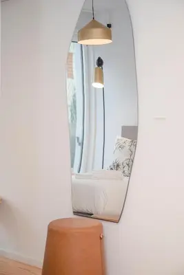 a room with a chair and a mirror at Liiiving in Porto - Modern & Glam Apartment M in Porto