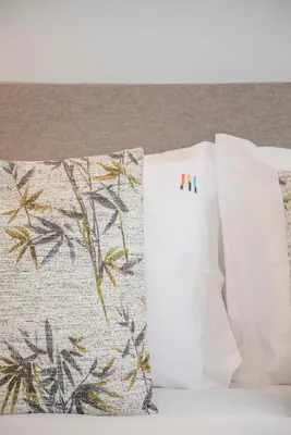 two white pillows sitting next to each other on a bed at Liiiving in Porto - Modern & Glam Apartment M in Porto
