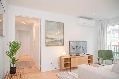 a living room with a couch and a television on a table at Liiiving in Porto - Modern & Glam Apartment M in Porto