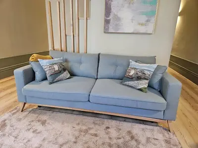 a blue couch sitting in a living room at São João Boutique Apartment in Porto