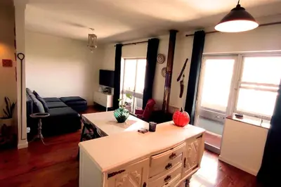 a living room with a table and a couch at DockApartment in Vila Nova de Gaia