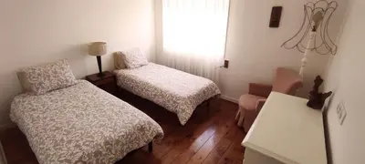 a small bedroom with two beds and a window at DockApartment in Vila Nova de Gaia