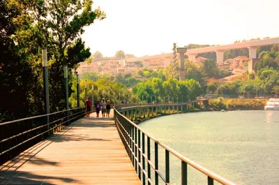 a bridge over a river with people walking on it at Gulbenkian 39 in Vila Nova de Gaia