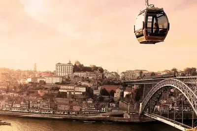 a gondola flying over a bridge over a river at Gulbenkian 39 in Vila Nova de Gaia