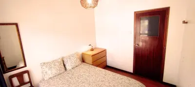 a bedroom with a bed and a dresser and a mirror at Gulbenkian 39 in Vila Nova de Gaia