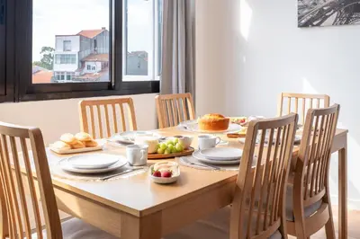 a dining room table with a plate of food on it at Host Wise - Comfy Minimalist Flat in Porto