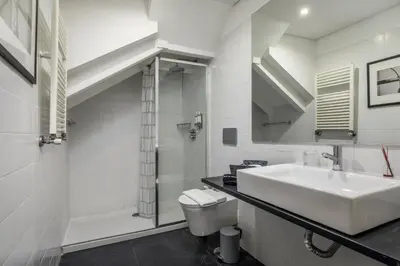 a white bathroom with a sink and a toilet at Clérigos Design by Hosty in Porto