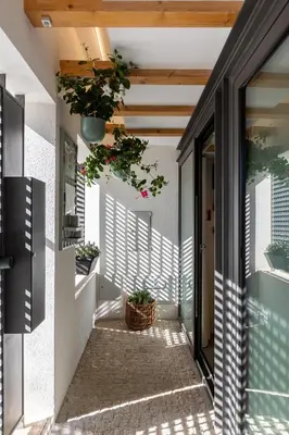 an internal courtyard of a house with potted plants at Urban Loft in Porto