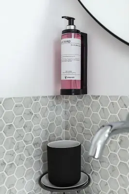 a bottle of soap sitting on top of a sink at Urban Loft in Porto