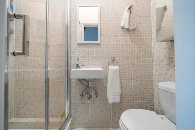 a bathroom with a shower with a sink and a toilet at Marquês Studio by Amber Star Rent in Porto