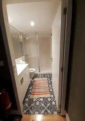 a bathroom with a shower and a toilet and a sink at Mezzanine in Porto