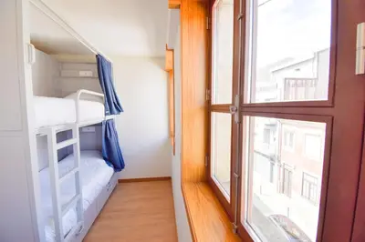a small room with a desk and bunk beds at Lindo Vale 412 in Porto