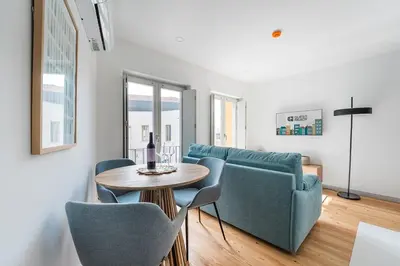 a living room with a couch and a table and chairs at GuestReady - Downtown Refuge with Private Parking in Porto
