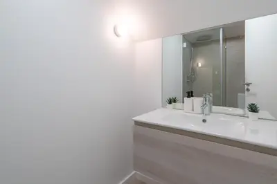 a bathroom with a white sink and a mirror at Host Wise - Central Duplex House - Terrace in Vila Nova de Gaia