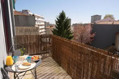 a kitchen with white counters and a wooden floor at *Lighty Santa Catarina Studio* Balcony/Dishwasher in Porto