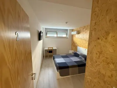 a small bedroom with a bed and a window at Porto Encanto- 7 Bedrooms in Porto
