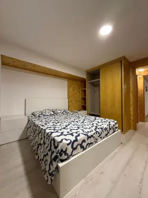 a bedroom with a bed with a black and white comforter at Porto Encanto- 7 Bedrooms in Porto