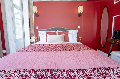 a red bedroom with a large bed with red walls at Authentic Porto Suites in Porto