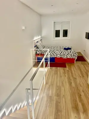 a bedroom with a bunk bed and a staircase at Oporto Blue Boavista - Deluxe City Center Duplex in Porto
