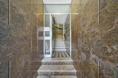 a hallway of a building with stone walls and stairs at Apartamento D' Alegria in Porto
