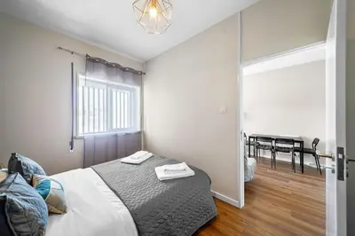 a bedroom with a bed and a table in a room at Apartamento D' Alegria in Porto