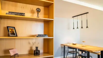 a room with a desk and a table and shelves at Capelo Residency by LovelyStay in Porto