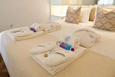 a group of towels on a bed at Boutique Rentals- THE CLéRiGoS Apt w/ patio in Porto
