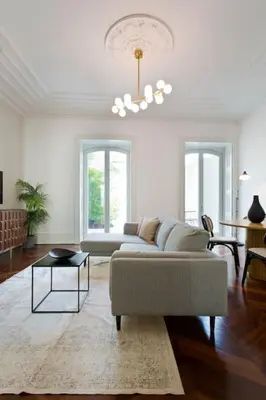 a living room with a couch and a table at Boutique Rentals- THE CLéRiGoS Apt w/ patio in Porto