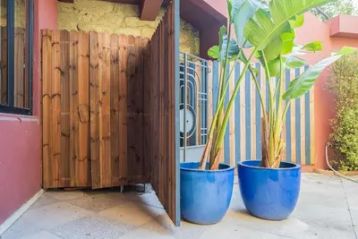 two blue pots with plants in them next to a fence at Liiiving in Porto - Casa Duque Apartments in Porto